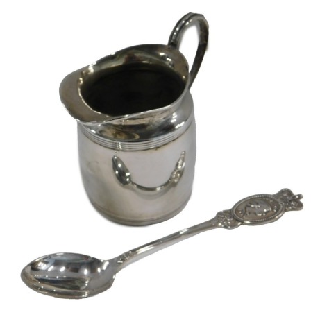 A small silver George V cream jug, Chester 1910, and an Elizabeth II silver Coronation spoon, 2.55oz overall.