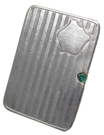 A George V silver stamp case, the sliding lid with engine turned bands and vacant cartouche, enclosing a gilt interior with green glass cabochon button, Birmingham 1911, 5cm long, 0.59oz.