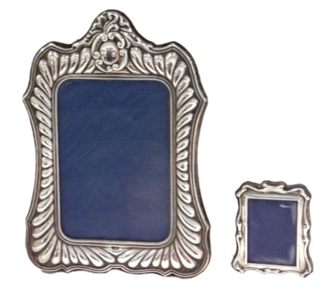 A modern silver mounted photograph frame, with gadrooned border, arched top, 20cm high, and a small silver mounted frame. (2)