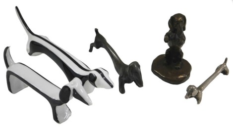 Two single novelty knife rests modelled in the form of Dachshunds, a Dachshund bronzed resin figure, a Cmielow porcelain figure of a Dachshund, and another similar stamped Tosco Germany. (5)