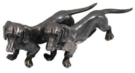 A WMF German silvered metal sculpture, modelled in the form of two Dachshunds, 12cm long.