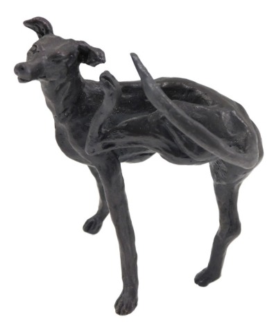 A bronzed metal cast figure of a scratching Greyhound, indistinctly signed, 12cm high.