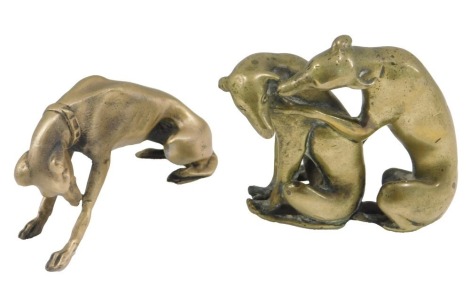 A cast metal figure of a seated Greyhound, 8cm long, and a brass cast ground of two Greyhounds, 6cm long.