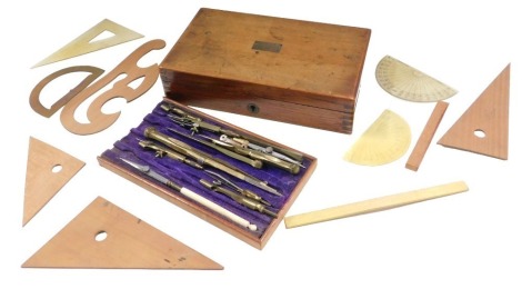 A set of early 20thC brass drawing instruments, etc., in a fitted mahogany case with vacant cartouche, 21cm wide.