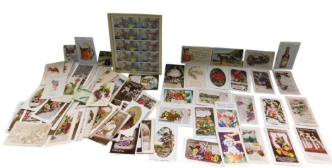 A quantity of early 20thC postcards and greetings cards, to include First World War embroidered silk examples, and a page of Russian stamps dated 1989.