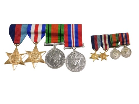 A set of WWII medals, a 1945 star, France and Germany star, Defence medal, and George VI medal, and miniatures.