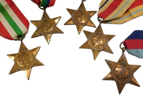 A collection of Second World War medals, the Italy Star, the Africa Star, the Pacific Star, the Atlantic Star, and the 1939-45 Star.