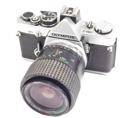 An Olympus OM2 camera, with lens.