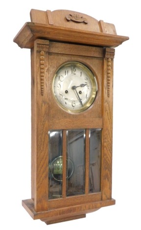 An oak wall clock, with silvered dial, 54cm high.