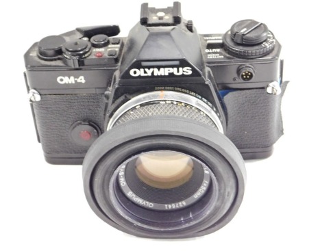 An Olympus OM-4 camera, with lens.