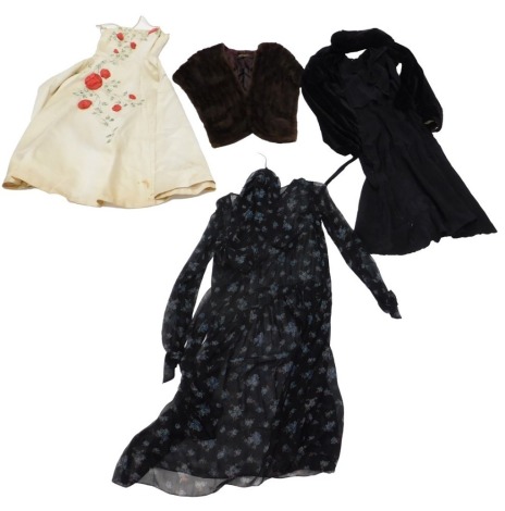 A group of vintage clothing, comprising a 1920s black mourning dress, together with a black velvet jacket, a 1950s pale yellow silk evening gown with applied rose decoration and a boned bodice, a Smith's of Bath & Bristol mink stole, and a contemporary fl