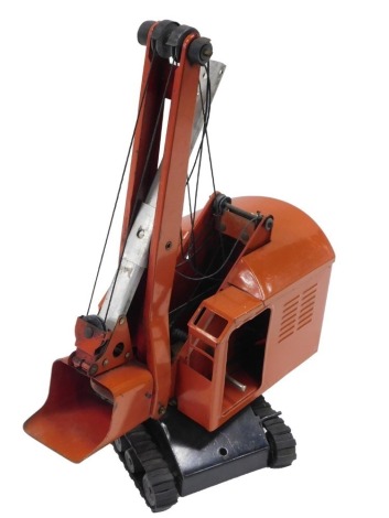 A Tri-ang red tinplate excavator.