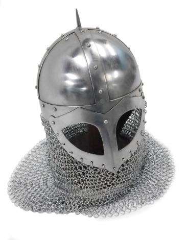 A reproduction medieval helmet, with chain mail collar, on an oak stand, 41cm high.