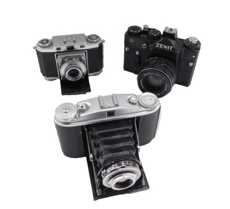 A Zenit 11 camera, with lens, and two other cameras.