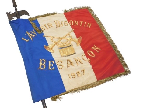 A French marching band flag, with pike, the flag named L'avenir Bisontin above crossed trumpets and a drum, Besancon 1927.