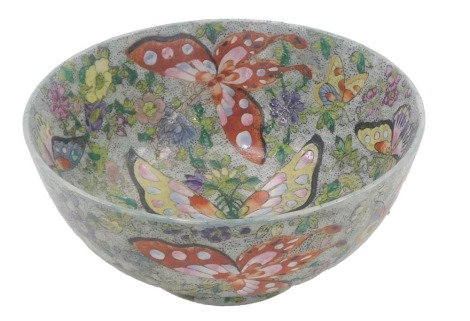 A modern Chinese porcelain bowl, decorated with butterflies, flowers, etc., six character mark to underside in red, 26cm diameter.