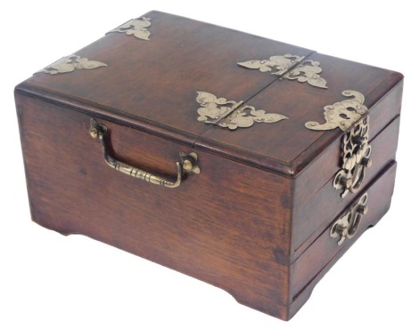 A Chinese hardwood and silver coloured metal mounted travelling dressing case, the hinged top with mirror, above two drawers, 17cm wide.