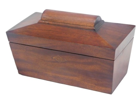 A 19thC mahogany sarcophagus shaped tea caddy, the hinged lid enclosing two lidded compartments, 24cm wide.