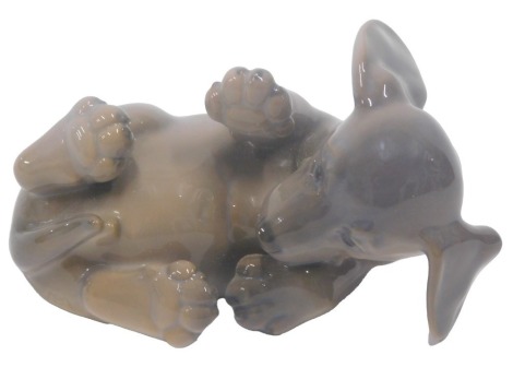 A Royal Copenhagen porcelain model of a Dachshund puppy on its back, numbered 1238 and 1408, 10cm wide.