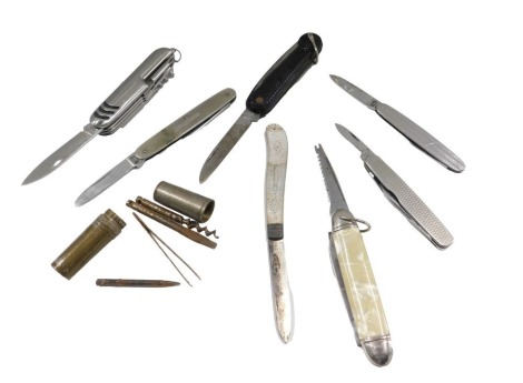 A quantity of penknives, etc., to include three with engine turned decoration, fruit knife with silver blade and mother of pearl, and a small set of tools to include corkscrew in silver plated case.