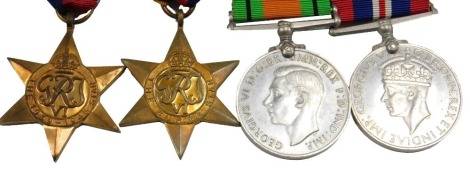 A group of four WWII medals, The 1939-45 star, The Burma star, The Defence Medal and The Campaign Medal.