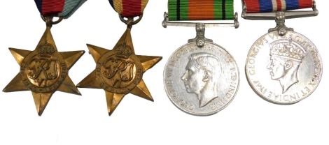 A group of four WWII medals, The 1939-45 star, The Africa star, The Defence Medal, and The Campaign Medal.