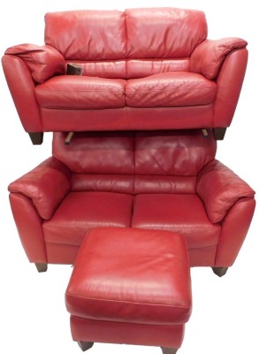 A set of two seat red leather sofas, and matching foot stool.