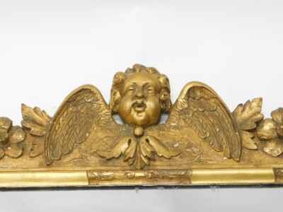 An 18thC gilt wood and gesso over mantel mirror, the crest decorated with a stylised angel flanked by flowers and leaves, above three mirror plates, flanked by drapes and scrolls, 77cm high, 117cm wide. - 2