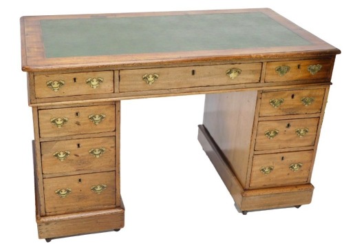 A Victorian mahogany pedestal desk, the top with a green leatherette inset, above an arrangement of nine drawers, on a plinth, 122cm wide.