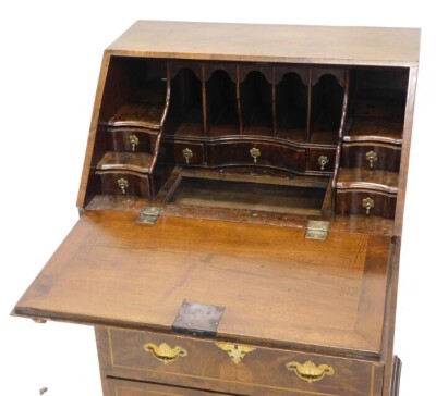 A walnut bureau in mid 18thC style, the fall enclosing a fitted interior, with well above two short and two long drawers, each with engraved brass bat shaped handles, and lozenge shaped escutcheons, on bracket feet, 61cm wide. - 2