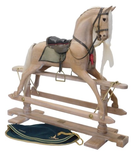 A Stevenson Brothers of England limed oak rocking horse, bearing original coat or jacket, brass plaque to base, dating 1996 and numbered 2352, 130cm long.