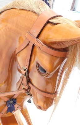 A Stevenson Brothers of England fruitwood rocking horse, wearing original blanket, on trestle base, applied with plaque, dating to 1998, 142cm long. - 5