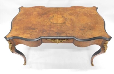 A Continental walnut and ebonised library table or bureau plat, the quarter veneered top above a shaped frieze with gilt metal mounts, on cabriole legs, 74cm high, 120cm wide. - 2