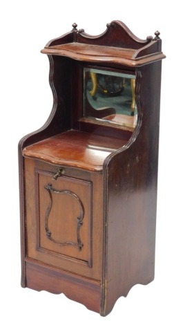 A late Victorian walnut coal purdonium, the top with a serpentine shaped shelf above a bevelled glass door, the base with a pull out drawer, lacking liner, on a plinth, 38cm wide.