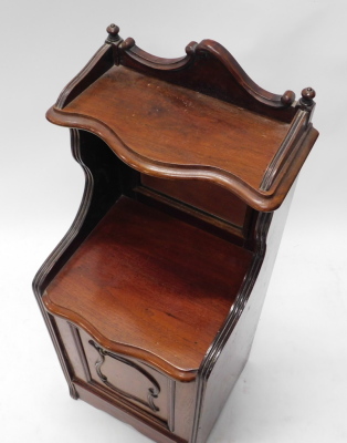 A late Victorian walnut coal purdonium, the top with a serpentine shaped shelf above a bevelled glass door, the base with a pull out drawer, lacking liner, on a plinth, 38cm wide. - 2