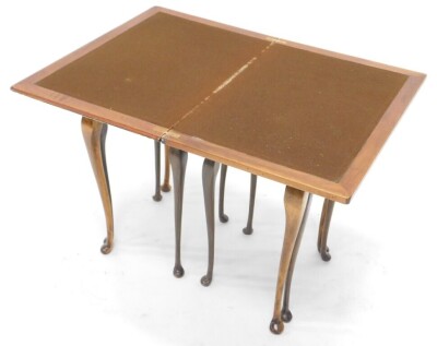 A 1920s burr walnut rectangular nest of three tables, the largest with fold over beige lined top, 56cm wide. - 2