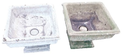 A pair of composition stone garden planters, each of square form, with scroll carved decoration, on pedestal base, 50cm high, 44cm diameter.