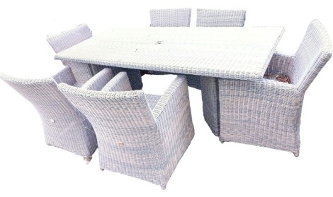 A Bellagio rattan garden set, comprising garden table, 73cm high, rectangular top, 610cm x 100cm, together with six chairs.