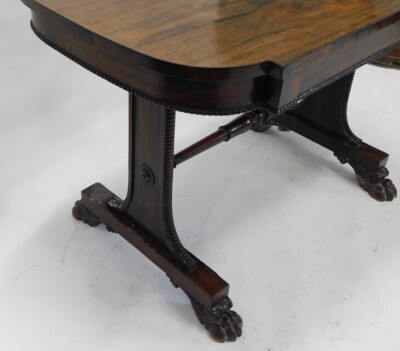 A William IV rosewood library table, the rectangular top with rounded ends, above a frieze drawer on tapering supports, united by turned stretcher, on paw feet, 72cm high, 112cm wide, 65cm deep. - 3