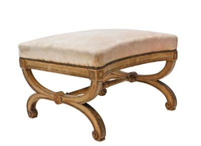 A 19thC walnut stool, with pink upholstered top with concave sides, on moulded x shaped supports, with turned stretcher, from a Duchess Brisee, 43cm high, 61cm wide.