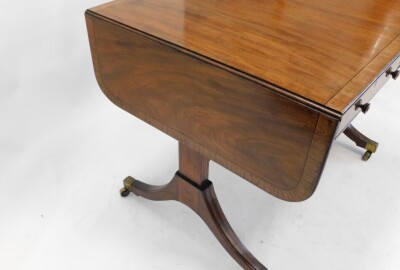 A Regency mahogany and rosewood cross banded sofa table, the rectangular top with rounded corners, above two frieze drawers on plain end supports, united by a stretcher, sabre legs, with brass castors, 145cm wide, 73cm deep. - 3