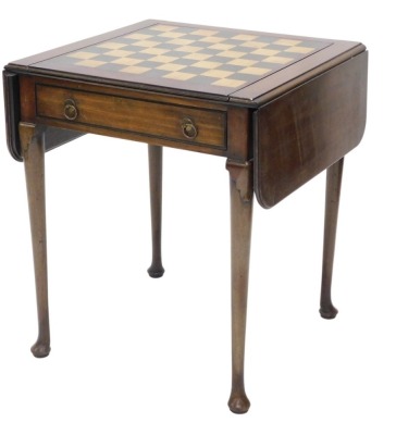 A mahogany drop leaf games table, the rectangular top with reversible lid for chess board, enclosing an interior inlaid for backgammon, above a frieze drawer, on turned tapering legs, with pad feet, possibly 18thC but adapted, 71cm high, 60cm wide.