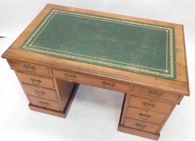 A late 19th/early 20thC walnut pedestal desk, the rectangular top with a green tooled leather insert, above an arrangement of nine drawers on a plinth, 77cm high, 123cm wide, 70cm deep. - 2