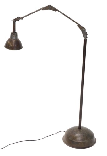 An industrial adjustable steel floor lamp, with domed foot, 100cm high. WARNING! This lot contains untested or unsafe electrical items. It is supplied for scrap or re-conditioning only. TRADE ONLY