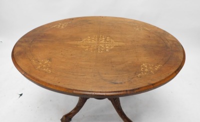 A Victorian walnut loo table, the oval tilt top on turned supports, with leaf carved splayed legs, 112cm wide. - 2