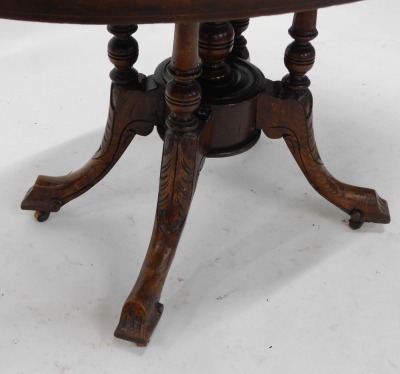 A Victorian walnut loo table, the oval tilt top on turned supports, with leaf carved splayed legs, 112cm wide. - 3