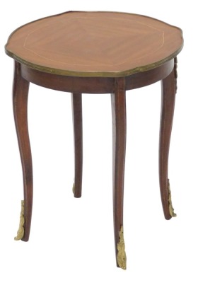 A Continental mahogany and gilt metal low table, the quarter veneered top with a shaped edge, on cabriole legs, 47cm high, 40cm wide.