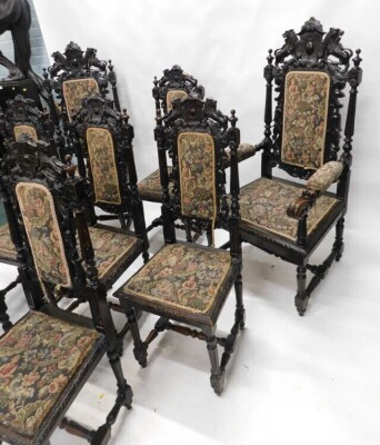 A set of eight late 19th/early 20thC ebonised oak dining chairs, in Caroleon style, each with a high leaf carved back, a padded seat, on fluted turned supports, with H stretcher, two with arms. - 4