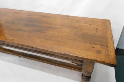 An oak refectory table in 17thC style, the rectangular planked top with a moulded frieze on turned supports, with flat H stretcher, 77cm high, 230cm wide, 91cm deep. - 2