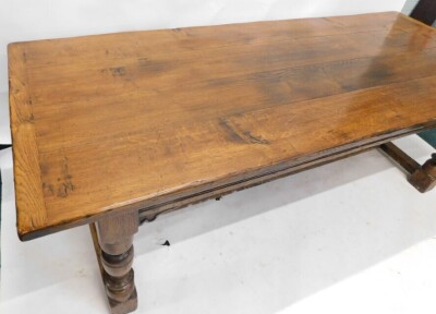 An oak refectory table in 17thC style, the rectangular planked top with a moulded frieze on turned supports, with flat H stretcher, 77cm high, 230cm wide, 91cm deep. - 3